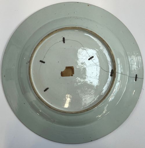 fig 5. A large circular Chinese export porcelain charger plate hand-painted with famille rose floral motifs, rockwork, and two white sheep on a pale background.