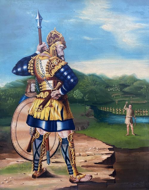 fig 2. An antique framed oil painting depicting Goliath clad in ornate gold and blue armour holding a spear, with David standing across a stream in the background.