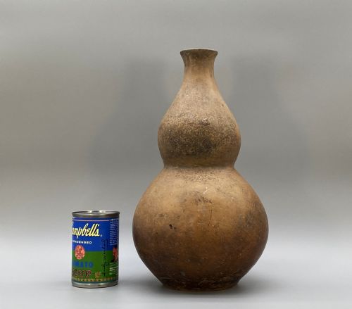 fig 1. A large terracotta ceramic vessel featuring a double gourd profile and a weathered brown unglazed finish.