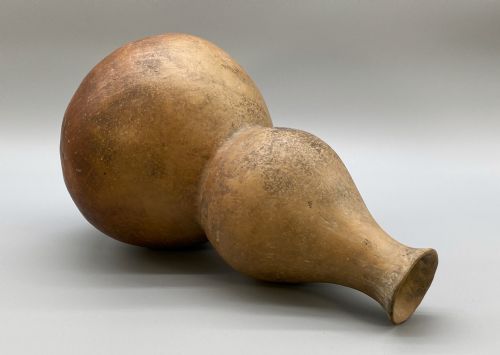 fig 4. A large terracotta ceramic vessel featuring a double gourd profile and a weathered brown unglazed finish.
