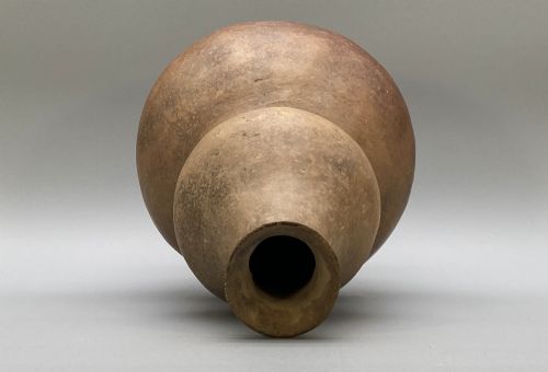 fig 5. A large terracotta ceramic vessel featuring a double gourd profile and a weathered brown unglazed finish.