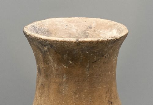 fig 6. A large terracotta ceramic vessel featuring a double gourd profile and a weathered brown unglazed finish.
