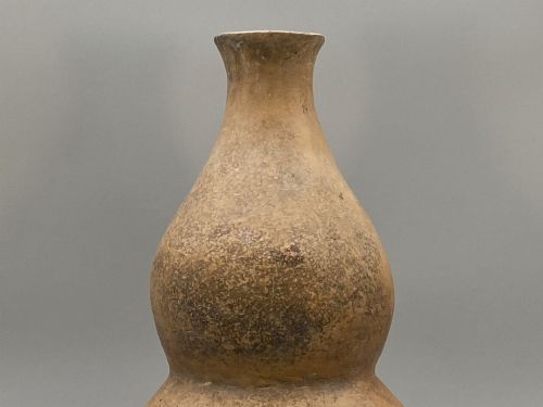 fig 7. A large terracotta ceramic vessel featuring a double gourd profile and a weathered brown unglazed finish.