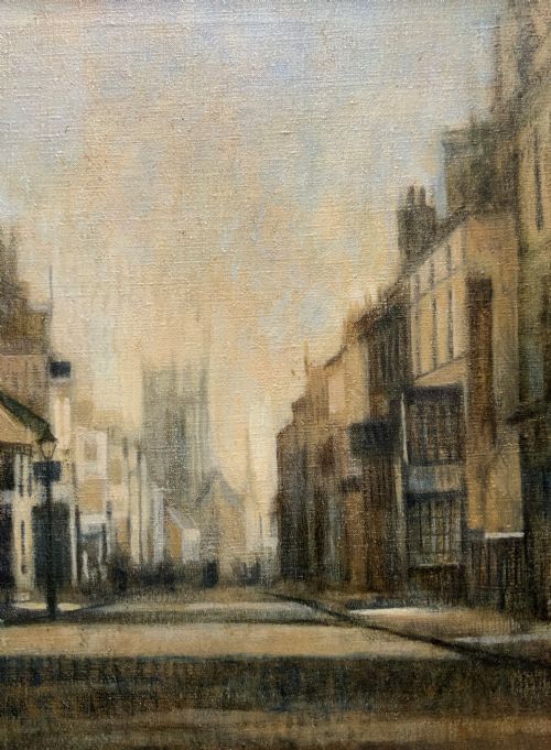 fig 2. A framed impressionist oil painting depicting a historic street scene with townhouses leading towards a church tower in muted brown, beige, and grey tones.