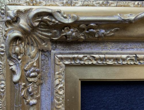 fig 2. An ornate 19th-century gold giltwood picture frame featuring intricate moulded gesso floral and shell embellishments around a central rectangular aperture.