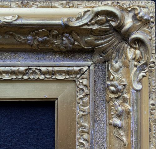 fig 3. An ornate 19th-century gold giltwood picture frame featuring intricate moulded gesso floral and shell embellishments around a central rectangular aperture.