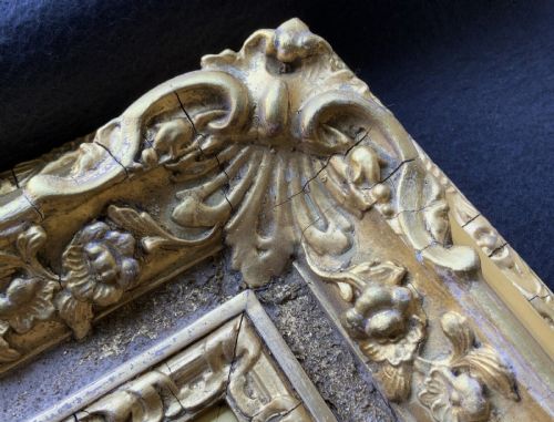 fig 4. An ornate 19th-century gold giltwood picture frame featuring intricate moulded gesso floral and shell embellishments around a central rectangular aperture.
