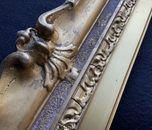 fig 5. An ornate 19th-century gold giltwood picture frame featuring intricate moulded gesso floral and shell embellishments around a central rectangular aperture.