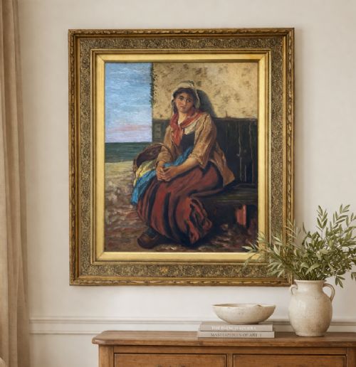 fig 1. A 19th-century oil painting depicting a young Dutch fisher girl in traditional costume seated near the sea, housed within an ornate gilt wooden frame.