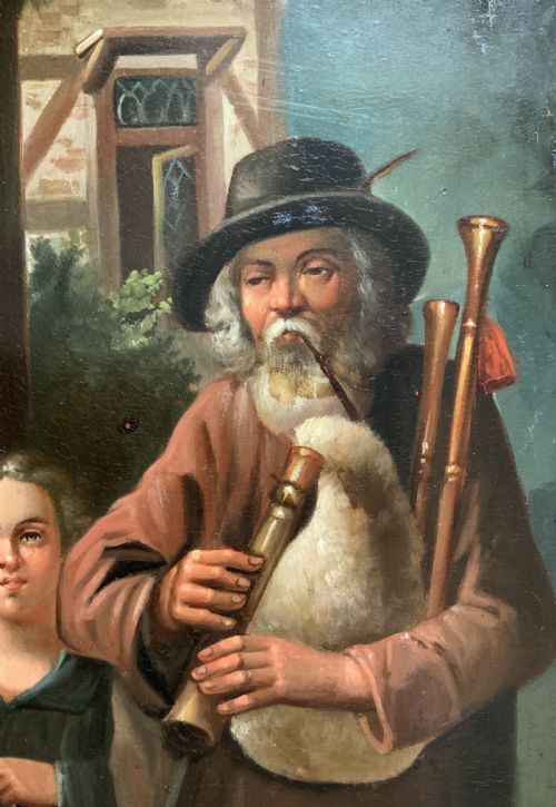 fig 5. An antique oil painting in a deep burr wood frame depicting an older bearded musician playing a bagpipe alongside a child holding an extended hat.