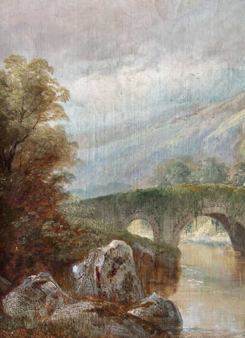 fig 4. A framed 19th-century oil painting depicting an arched stone bridge crossing a river amidst trees and distant mountains.