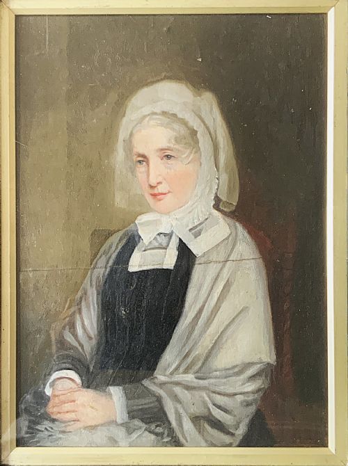 fig 2. A nineteenth-century oil portrait painting depicting a seated lady wearing a white lace bonnet and grey shawl, housed in a black ebonised frame with a pale inner slip.
