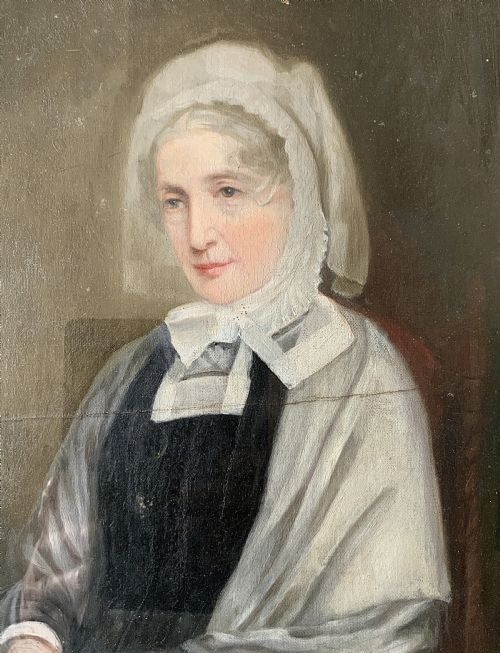 fig 5. A nineteenth-century oil portrait painting depicting a seated lady wearing a white lace bonnet and grey shawl, housed in a black ebonised frame with a pale inner slip.