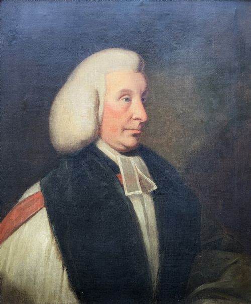 fig 2. An 18th-century oil portrait of a clergyman in a powdered wig and clerical bands, framed in a carved giltwood frame.