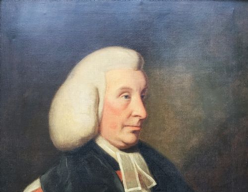fig 3. An 18th-century oil portrait of a clergyman in a powdered wig and clerical bands, framed in a carved giltwood frame.