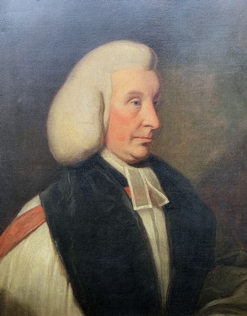 fig 6. An 18th-century oil portrait of a clergyman in a powdered wig and clerical bands, framed in a carved giltwood frame.