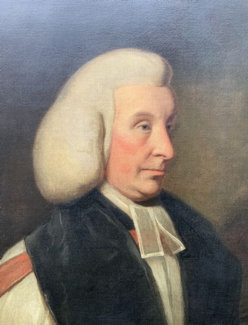 fig 7. An 18th-century oil portrait of a clergyman in a powdered wig and clerical bands, framed in a carved giltwood frame.
