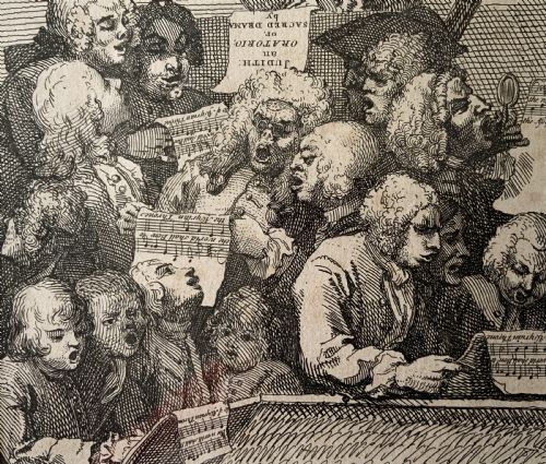 fig 3. A framed monochrome etching depicting a group of 18th-century choir singers holding music scores, set within a cream mount and a black and gold moulding frame.