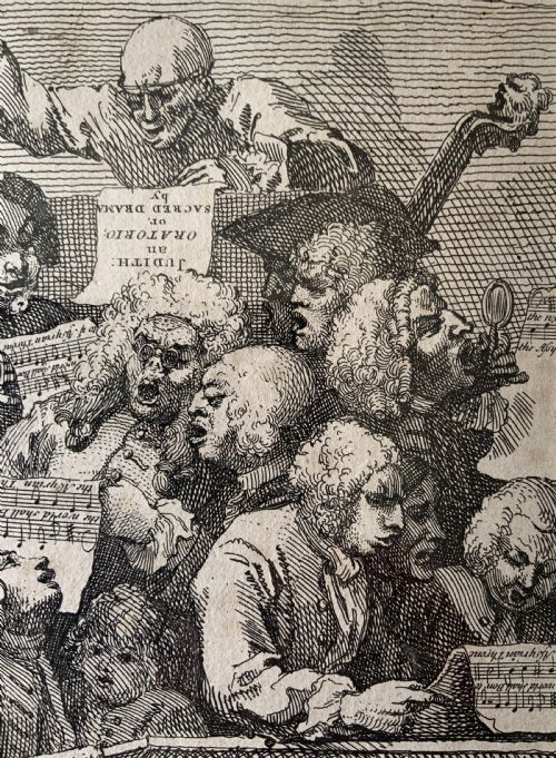 fig 4. A framed monochrome etching depicting a group of 18th-century choir singers holding music scores, set within a cream mount and a black and gold moulding frame.