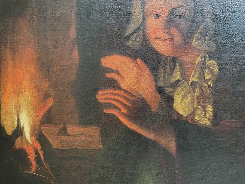 fig 6. A framed oil painting depicting a woman in historic dress warming her hands beside a glowing fire in a darkened interior.