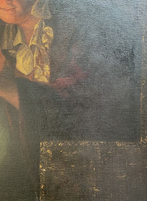 fig 8. A framed oil painting depicting a woman in historic dress warming her hands beside a glowing fire in a darkened interior.