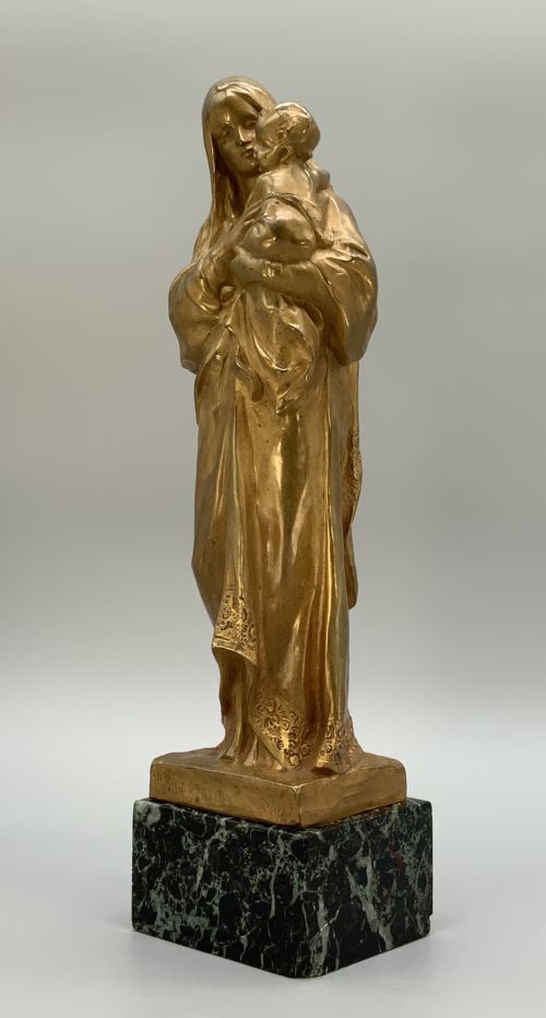 fig 8. A gilt bronze sculpture depicting the Madonna holding the infant Christ, mounted on a square dark green marbled base.