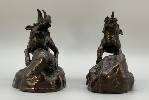 fig 5. A pair of patinated dark bronze Japanese mythical creature statues positioned on sculpted rocky bases.