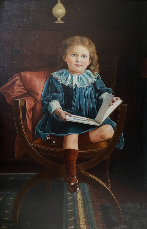 fig 2. An oil portrait on canvas depicting a young child in a blue dress seated in a wooden chair, enclosed within an ornate giltwood frame.