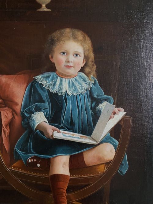 fig 3. An oil portrait on canvas depicting a young child in a blue dress seated in a wooden chair, enclosed within an ornate giltwood frame.