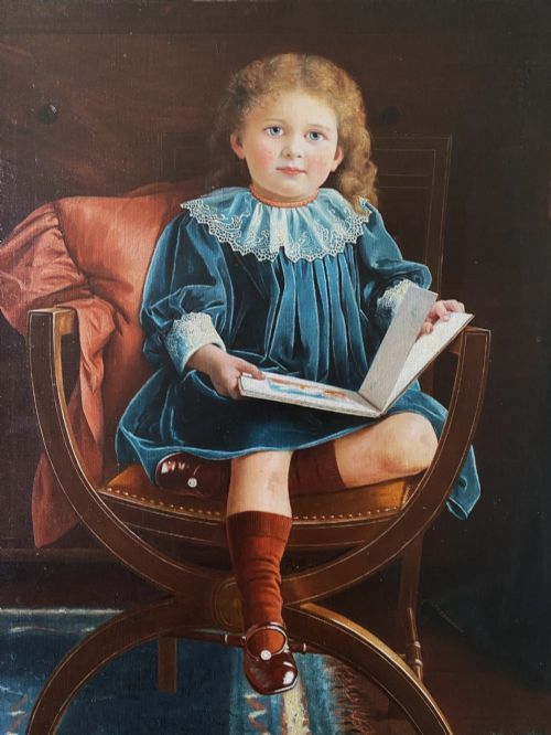 fig 9. An oil portrait on canvas depicting a young child in a blue dress seated in a wooden chair, enclosed within an ornate giltwood frame.