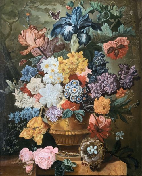fig 2. A gilt-framed oil painting featuring a dense bouquet of colourful flowers in a classical urn alongside a birds nest with eggs.