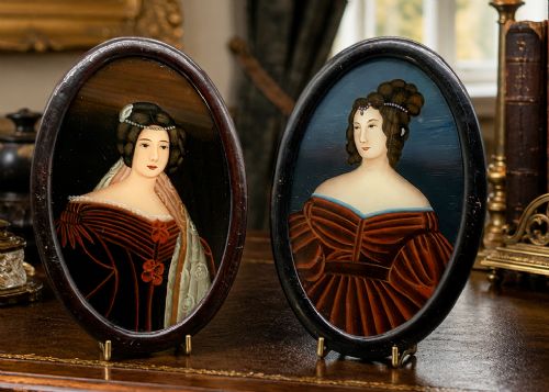 fig 1. A pair of Japanese Meiji period miniature portrait paintings in oval dark rosewood frames, depicting women in 19th-century style dresses.