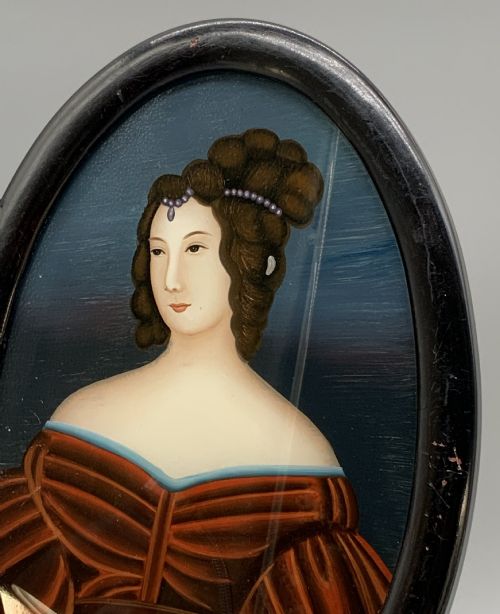 fig 4. A pair of Japanese Meiji period miniature portrait paintings in oval dark rosewood frames, depicting women in 19th-century style dresses.