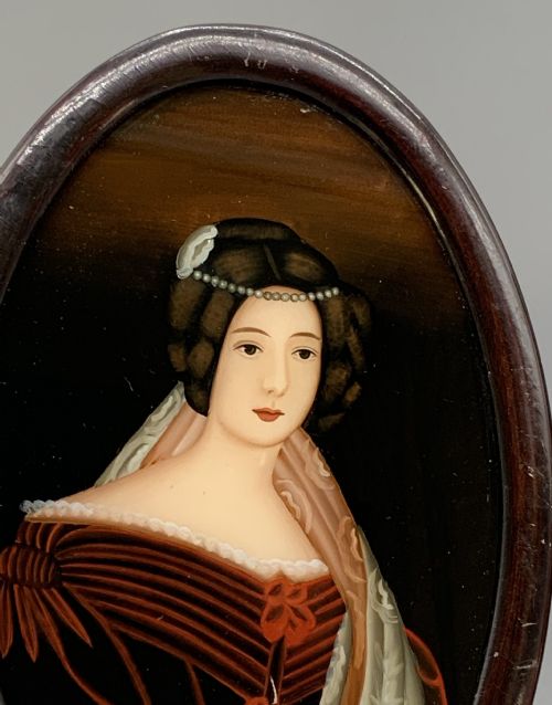 fig 6. A pair of Japanese Meiji period miniature portrait paintings in oval dark rosewood frames, depicting women in 19th-century style dresses.