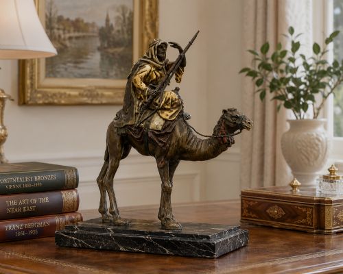 fig 1. An Austrian cold-painted bronze sculpture depicting a turbaned Arab rider holding a rifle while seated atop a standing camel.