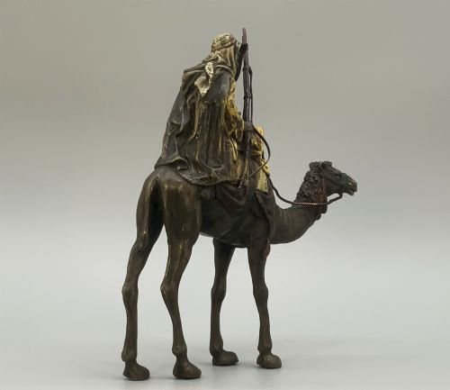 fig 6. An Austrian cold-painted bronze sculpture depicting a turbaned Arab rider holding a rifle while seated atop a standing camel.