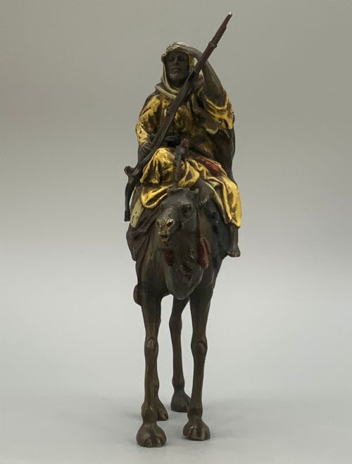 fig 10. An Austrian cold-painted bronze sculpture depicting a turbaned Arab rider holding a rifle while seated atop a standing camel.
