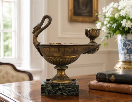 fig 1. A nineteenth-century Grand Tour patinated bronze oil lamp featuring a serpent handle and gadrooned body, mounted on a square green marble base.