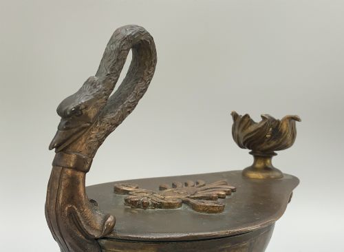 fig 4. A nineteenth-century Grand Tour patinated bronze oil lamp featuring a serpent handle and gadrooned body, mounted on a square green marble base.