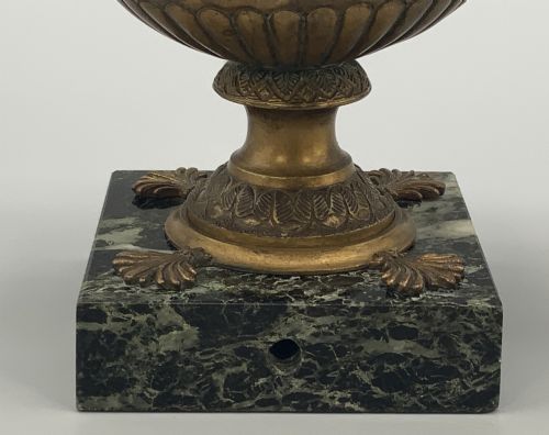 fig 6. A nineteenth-century Grand Tour patinated bronze oil lamp featuring a serpent handle and gadrooned body, mounted on a square green marble base.