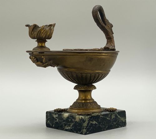 fig 9. A nineteenth-century Grand Tour patinated bronze oil lamp featuring a serpent handle and gadrooned body, mounted on a square green marble base.