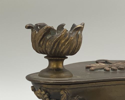 fig 10. A nineteenth-century Grand Tour patinated bronze oil lamp featuring a serpent handle and gadrooned body, mounted on a square green marble base.
