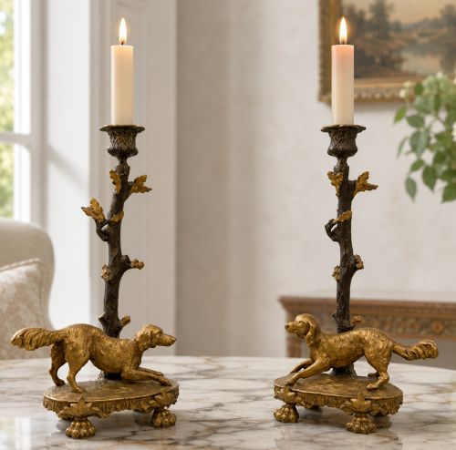 fig 1. A pair of 19th-century gilded and patinated bronze candlesticks featuring detailed figures of hunting dogs at the base beneath tree-branch shafts.