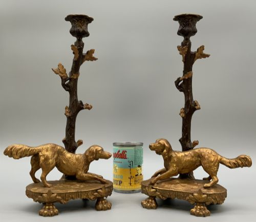 fig 2. A pair of 19th-century gilded and patinated bronze candlesticks featuring detailed figures of hunting dogs at the base beneath tree-branch shafts.