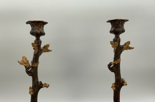 fig 4. A pair of 19th-century gilded and patinated bronze candlesticks featuring detailed figures of hunting dogs at the base beneath tree-branch shafts.