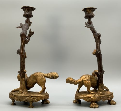 fig 6. A pair of 19th-century gilded and patinated bronze candlesticks featuring detailed figures of hunting dogs at the base beneath tree-branch shafts.