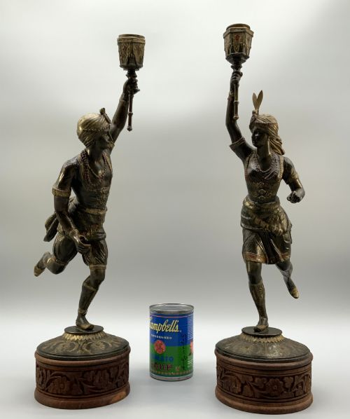 fig 2. A pair of 19th-century polychrome spelter figural candlesticks depicting male and female torchbearer figures raised on carved wooden bases.