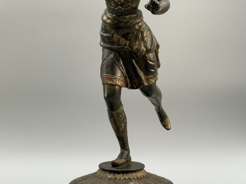 fig 7. A pair of 19th-century polychrome spelter figural candlesticks depicting male and female torchbearer figures raised on carved wooden bases.