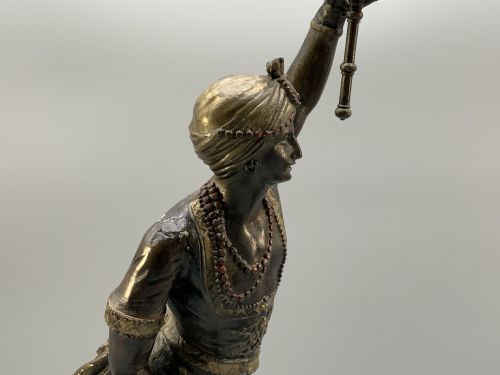 fig 9. A pair of 19th-century polychrome spelter figural candlesticks depicting male and female torchbearer figures raised on carved wooden bases.