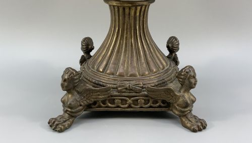 fig 8. A Renaissance Revival faience vase featuring blue and yellow glazed classical medallion artwork mounted on a cast bronze footed base with mask handles.